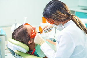 dentist performing dental bonding sugarland tx