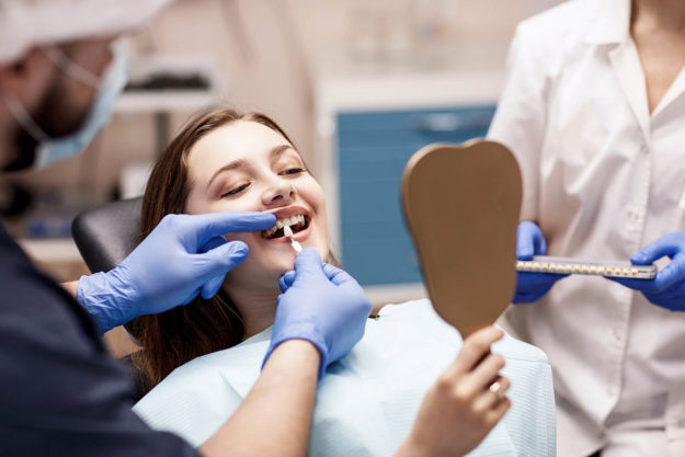 teeth whitening options (2) teen girl receiving Teeth Whitening Options at dentist office