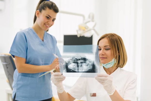 bone grafting Dentist explains bone grafting to patient.