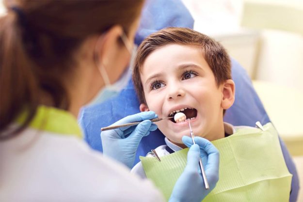 childens-dentist kid getting treatment at childrens dentist