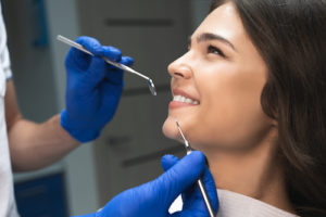 doctor prepares a woman for a root canal 